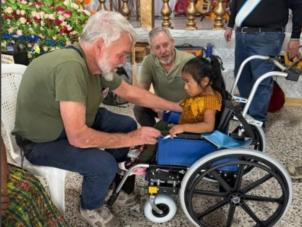 Little girl being fitted for a wheelchair.